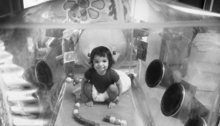 David Vetter as todler in bubble with toys.