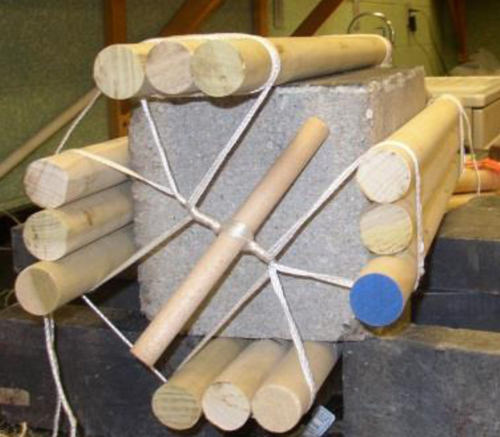 wooden dowels strapped to rock