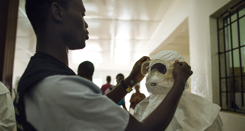 putting on protective gear against Ebola