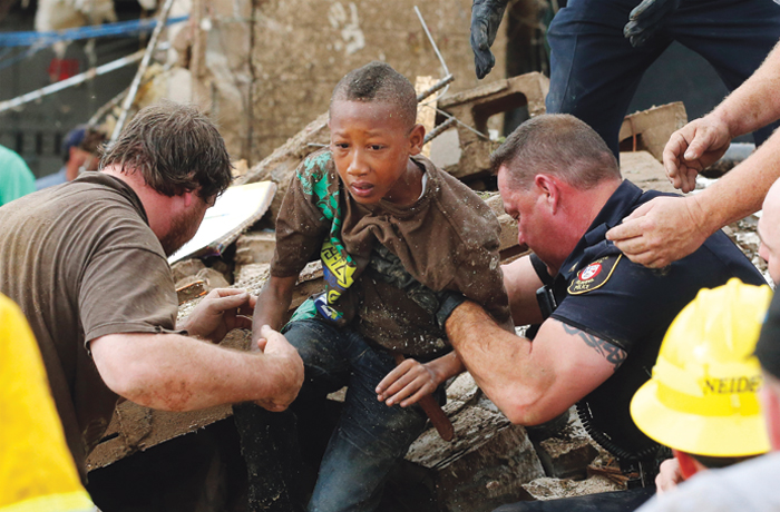 boy being helped out of wreckage of Oklahoma tornado