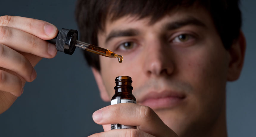 man holding vaping liquid