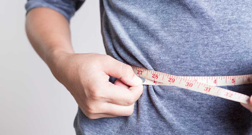 person measuring waist