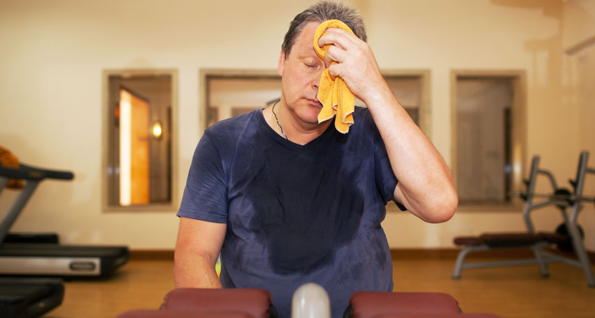 man sweating while working out