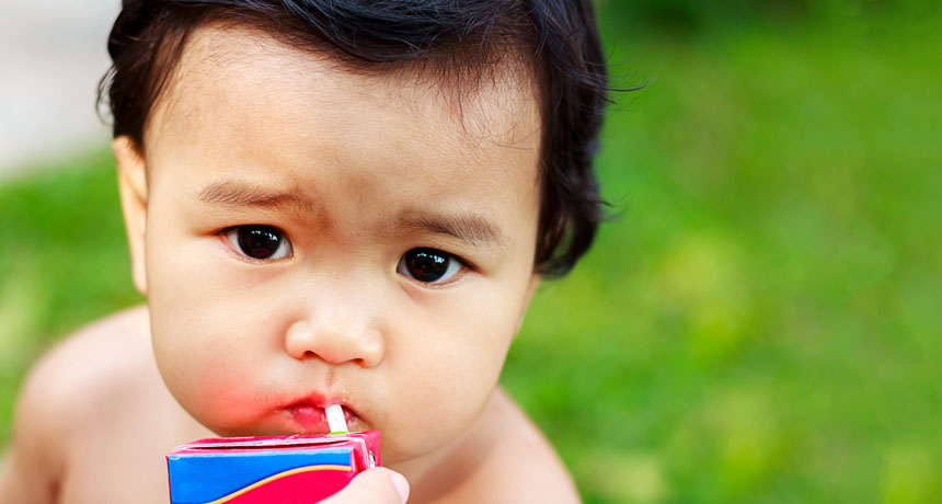baby drinking from juice box