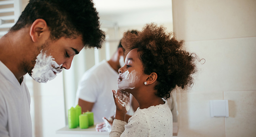 little girl shaving with daddy