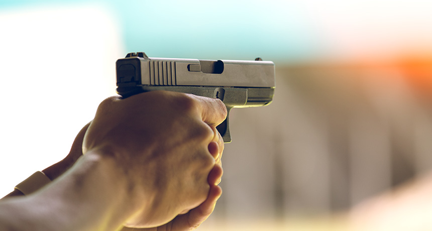 hands holding a gun