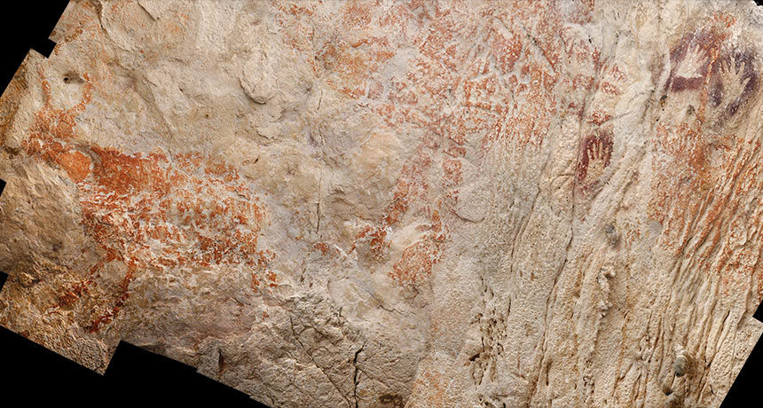 cave painting of red animal in Borneo