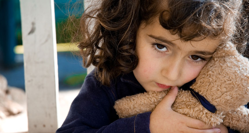 child holding a teddy bear