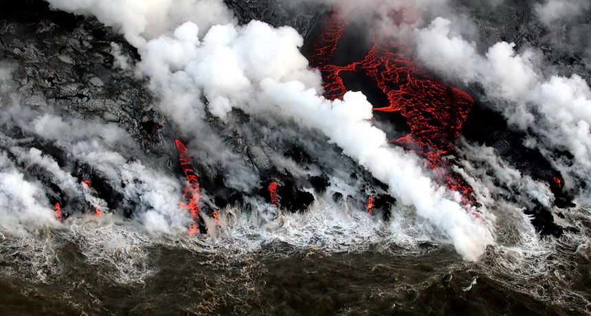 a photo of lava pouring into the Pacific Ocean