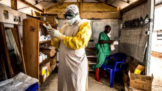 a photo of a doctor putting on protective gear