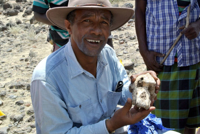 Yohannes Haile-Selassie holding skull