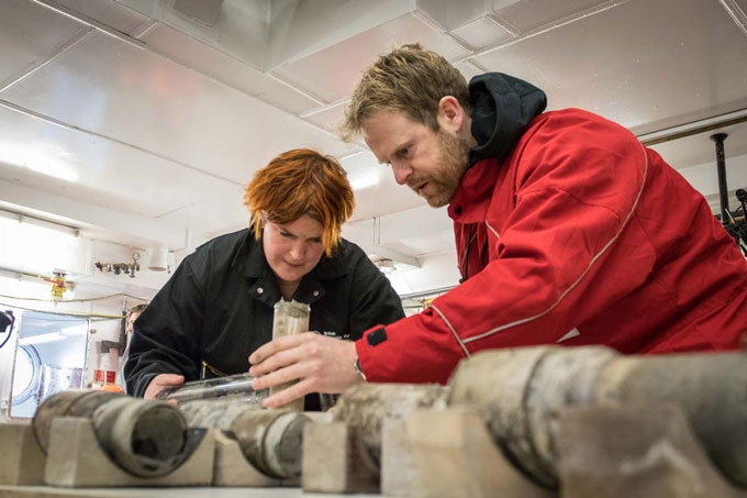 researchers with a sediment core