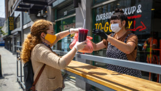 People wearing masks at a restaurant