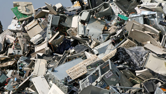 huge pile of discarded keyboards, computers and more