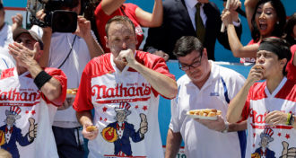 Joey Chestnut eating hot dogs at the 2019 Nathan's Famous Hot Dog Eating Contest