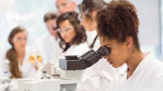 Student looking into a microscope