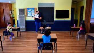 Teacher reads to children