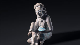 Maya sculpture of woman holding child
