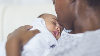 Black person holding Black baby