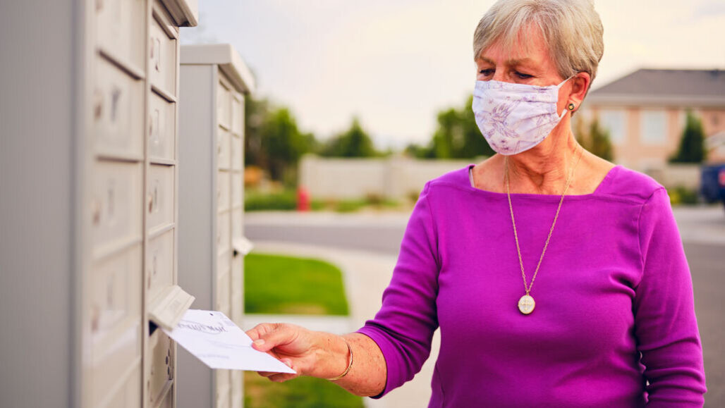 Woman mailing voting ballot