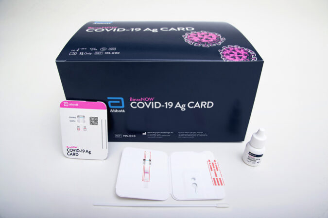 box showing text kit, with examples of the test cards, a swab and a bottle of solution