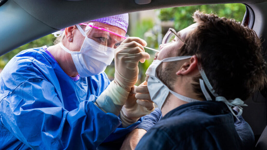 Person in a car getting a nasal swab test