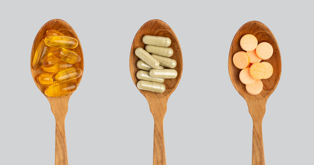 supplement pills in spoons