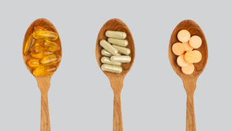 supplement pills in spoons