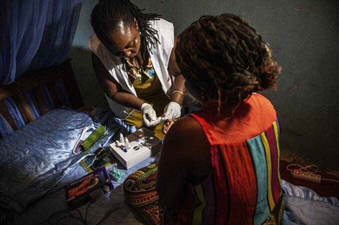 A nurse prepares to test a woman for HIV