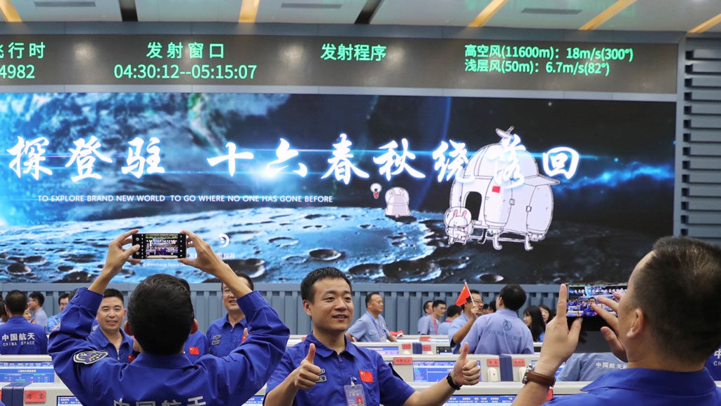 team members of China’s Chang’e-5 mission celebrating the spacecraft’s launch