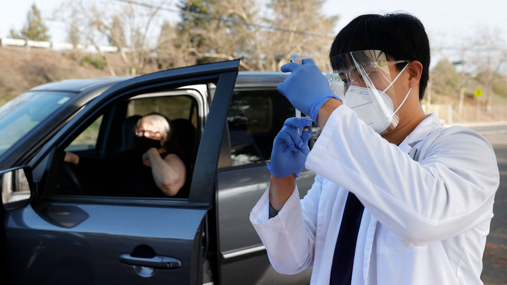 woman getting vaccinated at a drive-through clinic
