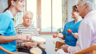 people playing instruments in a nursing home environment