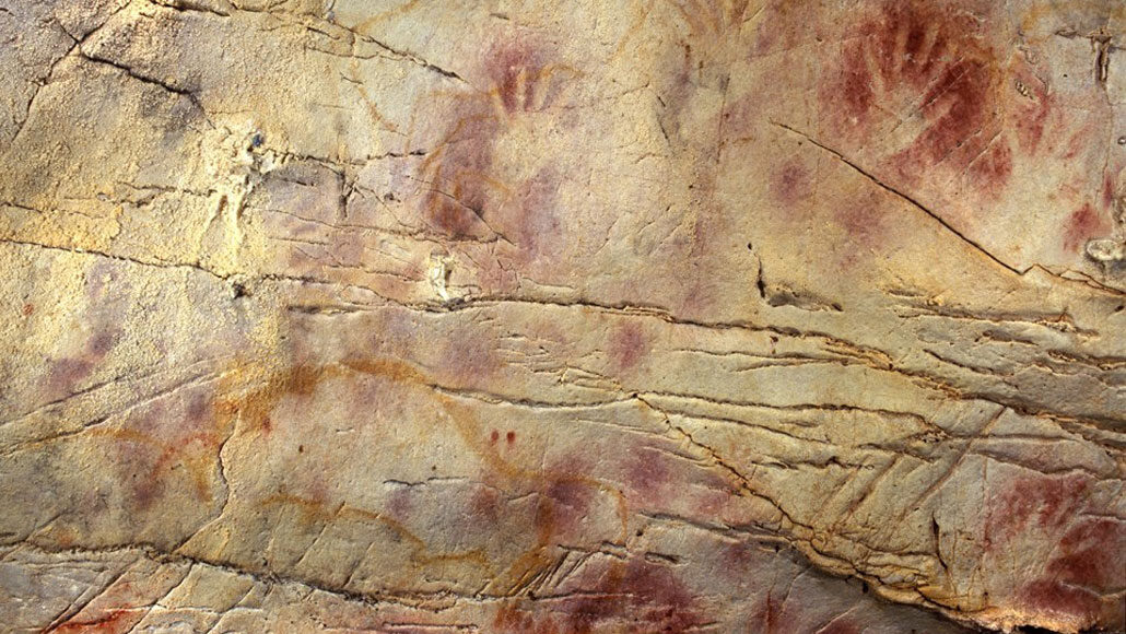 red ochre handprints in a cave