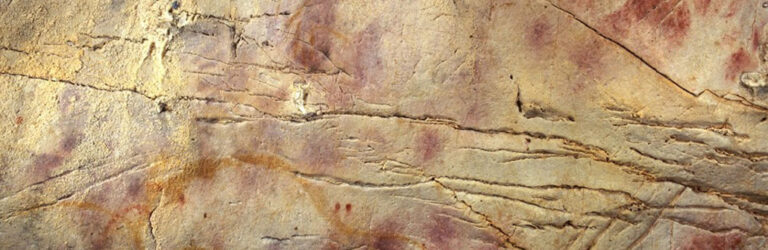 red ochre handprints in a cave