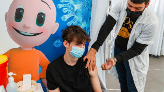 a 16-year-old receiving a covid-19 vaccine in Tel Aviv