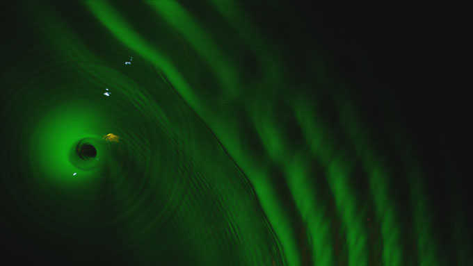 a water vortex lit with green light