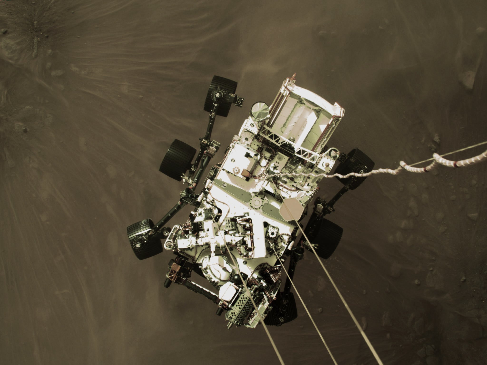 image of rover dangling above Mars surface