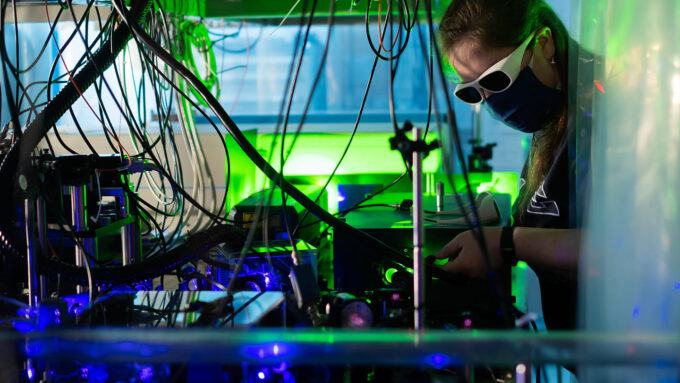 researcher working on laser-cooled plasma experiment