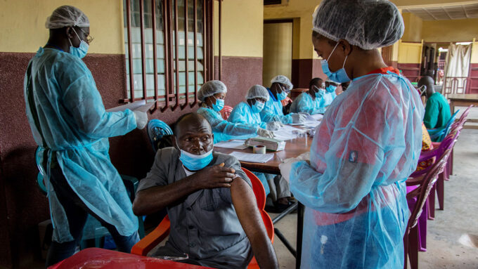 man receiving an Ebola vaccination in Guinea