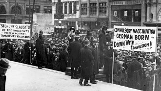 a black and white photo showing an anti-vaccination demonstration