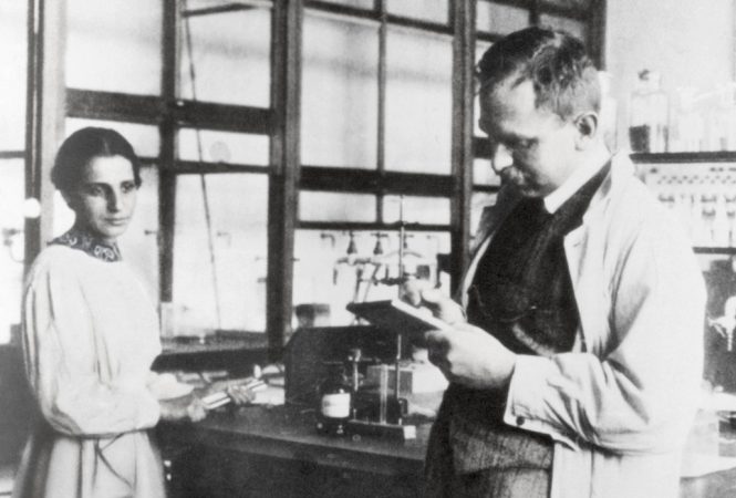 black and white photo of a woman and man in a lab