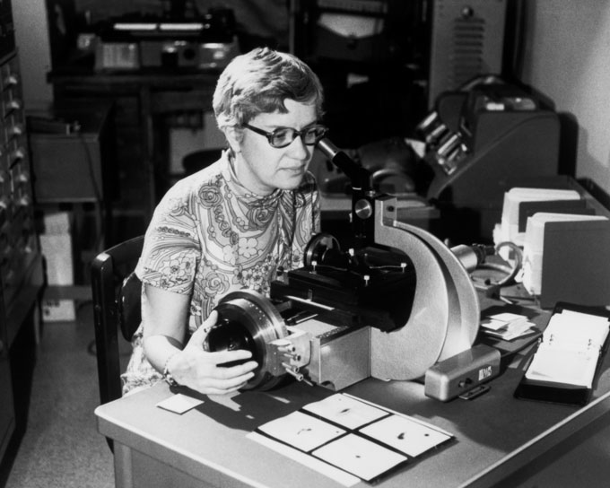 black and white photograph of Vera Rubin seated at a desk