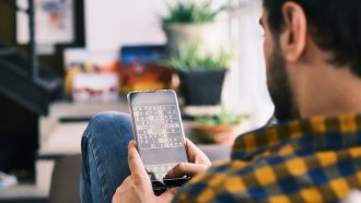 person playing brain training game on smartphone