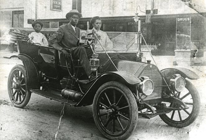 black and white image of the Williams family in a nice car