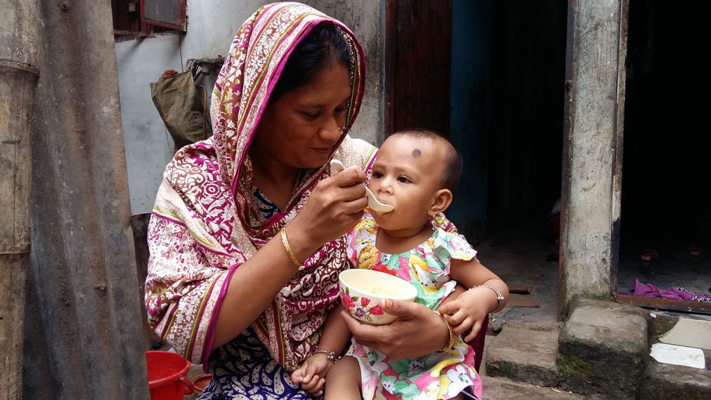 mother in Bangladesh feeding malnourished child