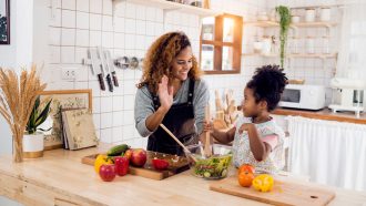stock image of a mother and daughter in the kitchen