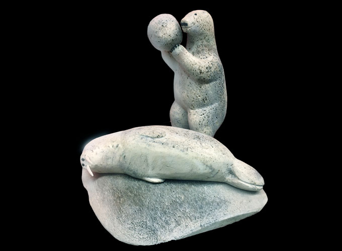 sculpture of polar bear lifting block of ice over the head of a sleeping walrus