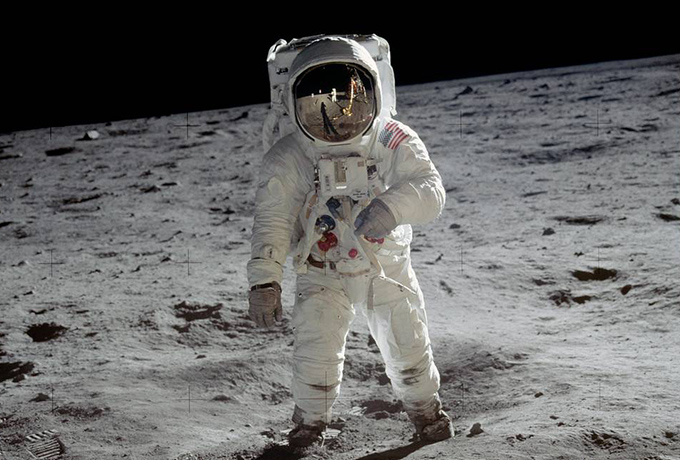 Buzz Aldrin in a space suit standing on the moon
