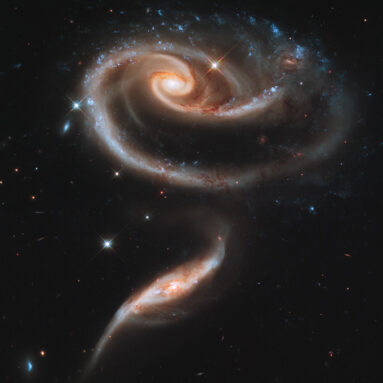 a pair of spiral galaxies, one above the other