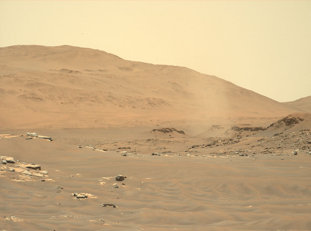 a tornado-like dust devil swirls across a brown Martian landscape